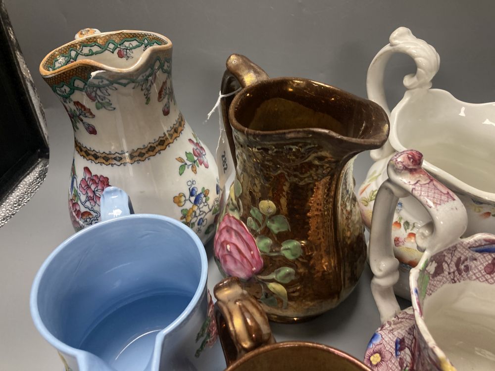 A collection of eleven lustre jugs and a mug, tallest 21cm